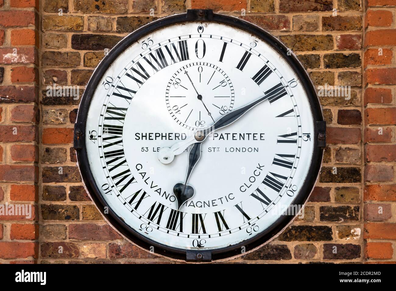 The Shepherd Gate Clock is mounted on the wall outside the gate of the Royal Greenwich Observatory in London. It is unusual as it has a twenty four ho Stock Photo