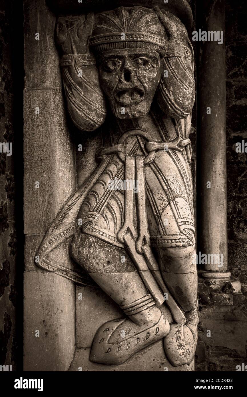 Face of exhaustion and despair on this shackled prisoner, knees