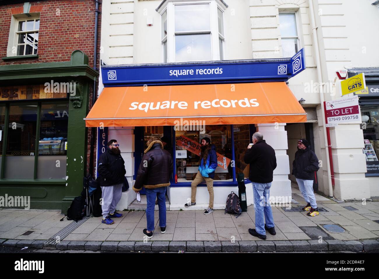 Queues For Record Store Day August 29th 2020 Outside Square Records Wimborne. RSD this year of 2020 with covid self distancing measures in place now takes place of three different days. Under the name of Record Day Store Drops, the first day takes place on 29th August. Over 200 independent record stores take part in RSD where fans of vinyl cand purchase, new, limited editions, rare and reissued records. Stock Photo