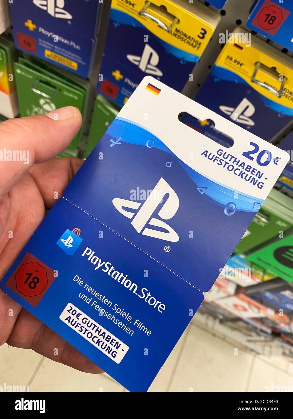 Viersen, Germany - July 9. 2020: View on playstation gift voucher card hold  by hand in german supermarket (focus on card Stock Photo - Alamy