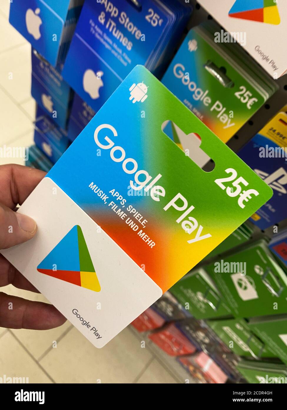 Viersen, Germany - July 9. 2020: View on google play gift voucher card hold by hand in german supermarket (focus on card) Stock Photo