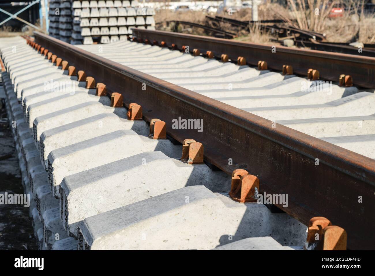 New rails and sleepers. The rails and sleepers are stacked on each other. Renovation of the railway. Rail road for the train Stock Photo