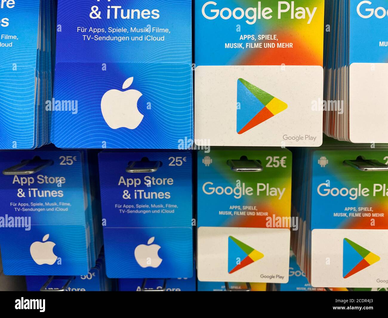 Viersen, Germany - July 9. 2020: View on apple itunes, app store and google music play gift voucher cards in shelf of german supermarket Stock Photo