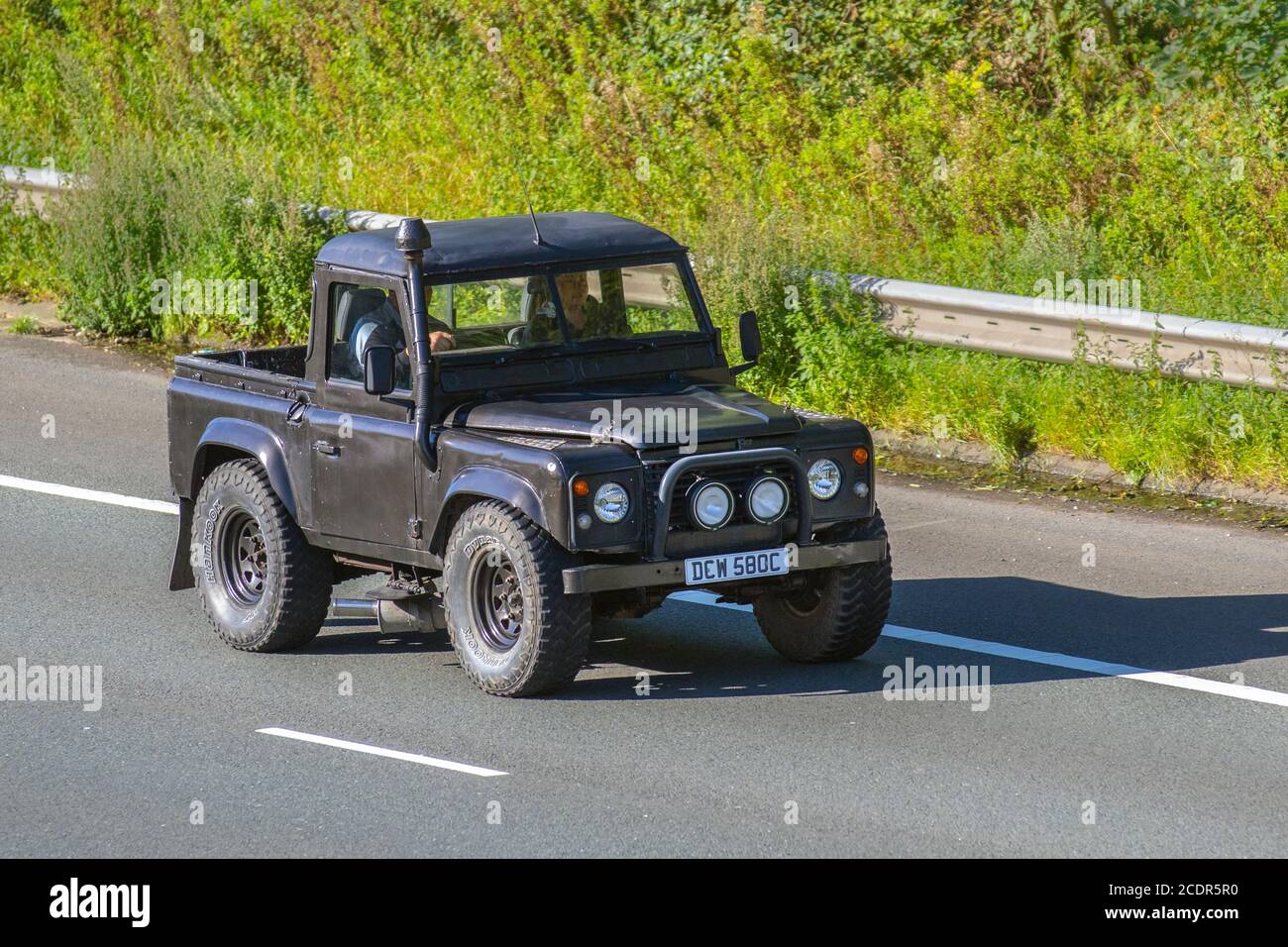 1965 60s Land Rover 88' - 4 CYL pick up; Vehicular traffic moving vehicles, cars driving a vehicle on UK roads, motors, motoring on the M6 motorway highway network. Stock Photo