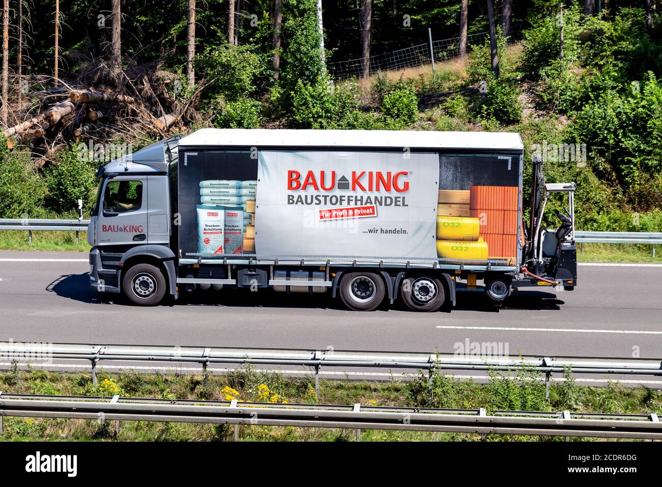 BAUKING truck on motorway. BAUKING is one of the market leaders in the German building materials and timber trade. Stock Photo