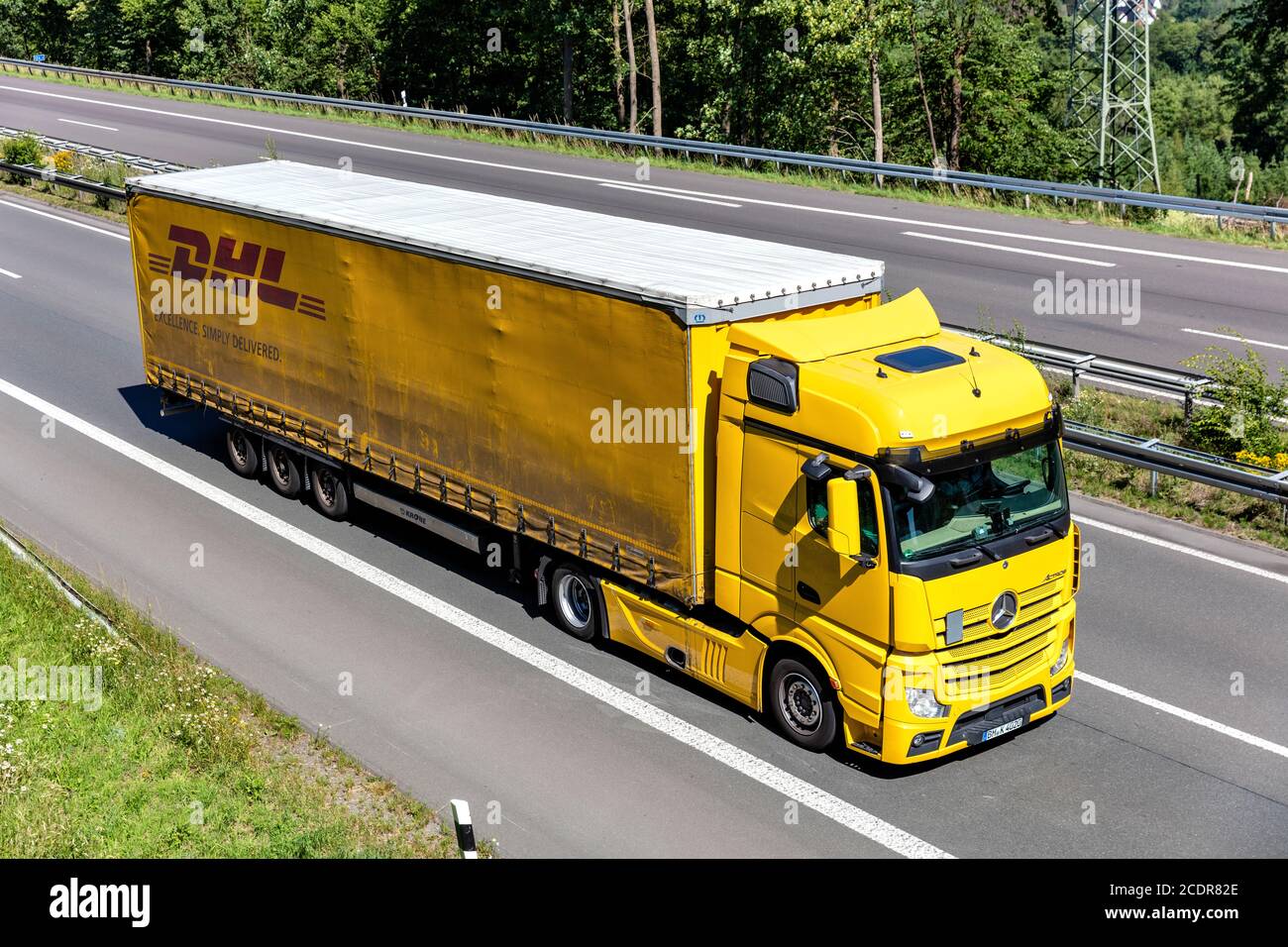 Mercedes-Benz Actros truck with DHL curtainside trailer on motorway Stock  Photo - Alamy
