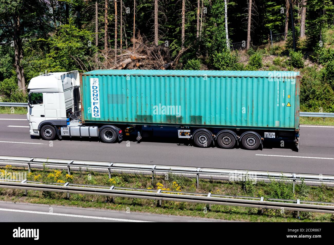 DAF XF truck with Dong Fang container on motorway. Stock Photo
