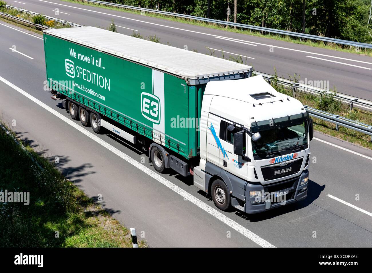 Kördel MAN TGX truck with E3 Spedition curtainside trailer on motorway. Stock Photo