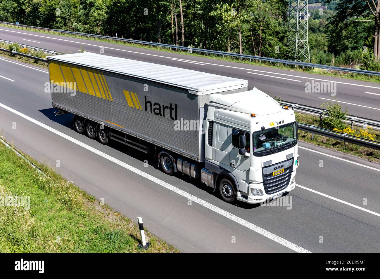 hartl DAF XF truck with curtainside trailer on motorway. Stock Photo
