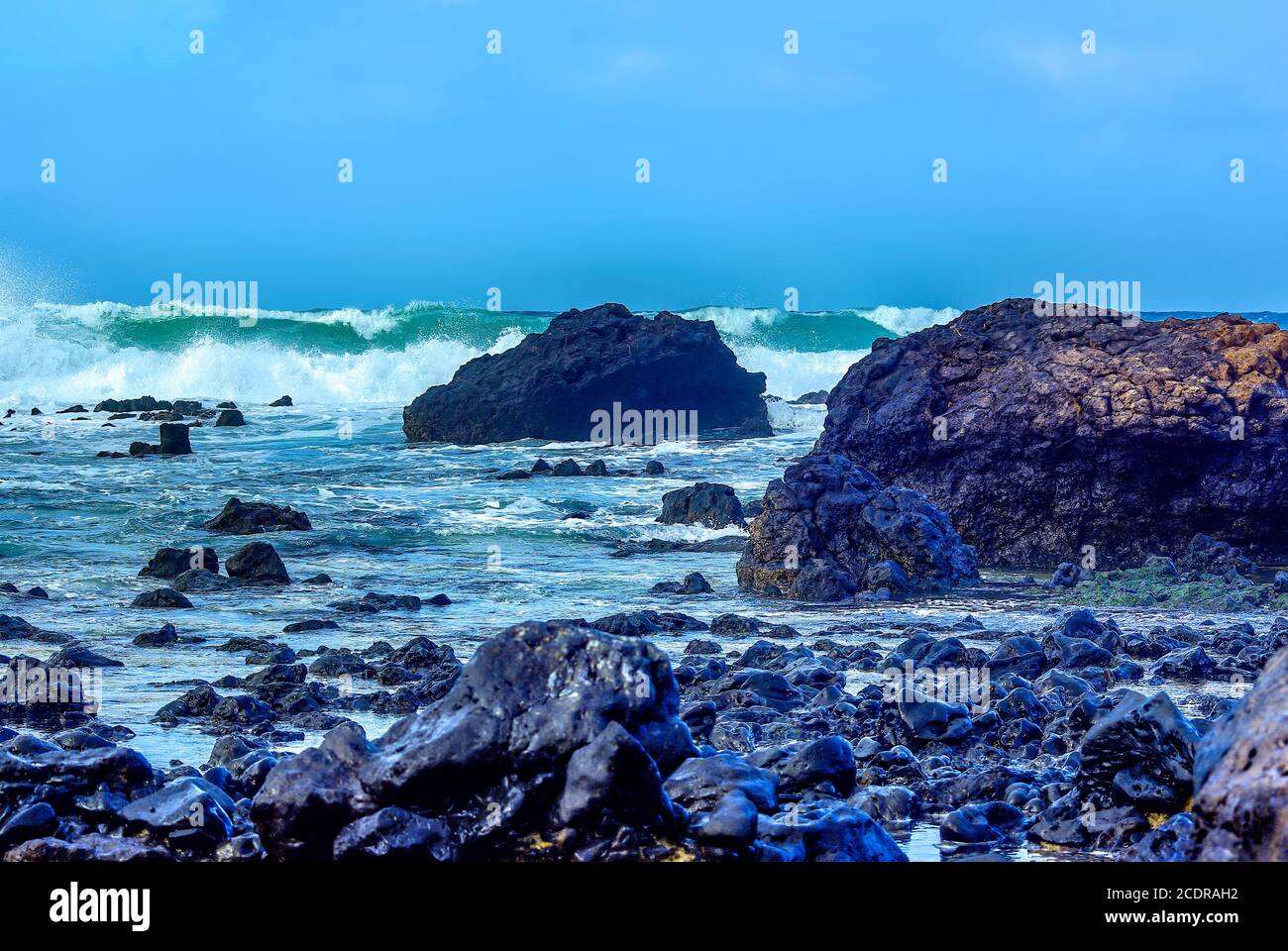 Breaking of waves and volcanic rocks on the coast near Orzola, Lanzarote, Spain. Stock Photo