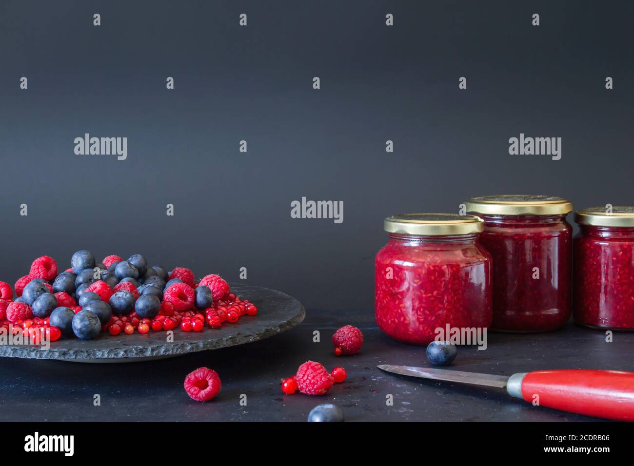 Homemade blueberries, raspberries and redcurrant jam on glas jars Stock Photo