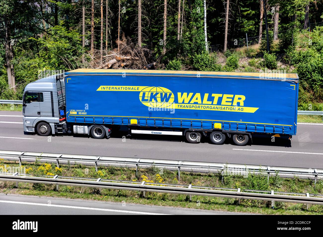 MAN TGX truck with LKW Walter curtainside trailer on motorway. Stock Photo