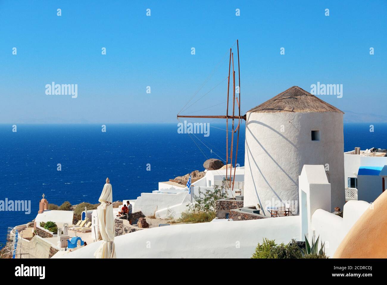 Santorini island with traditional windmill in Greece. Stock Photo