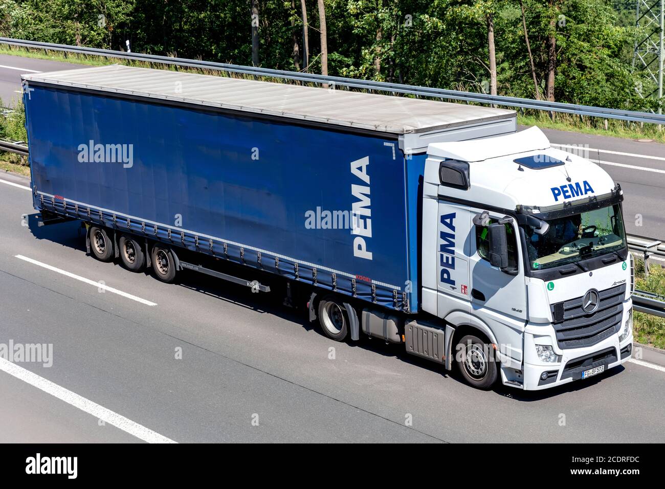 PEMA Mercedes-Benz Actros truck with curtainside trailer on motorway. Stock Photo