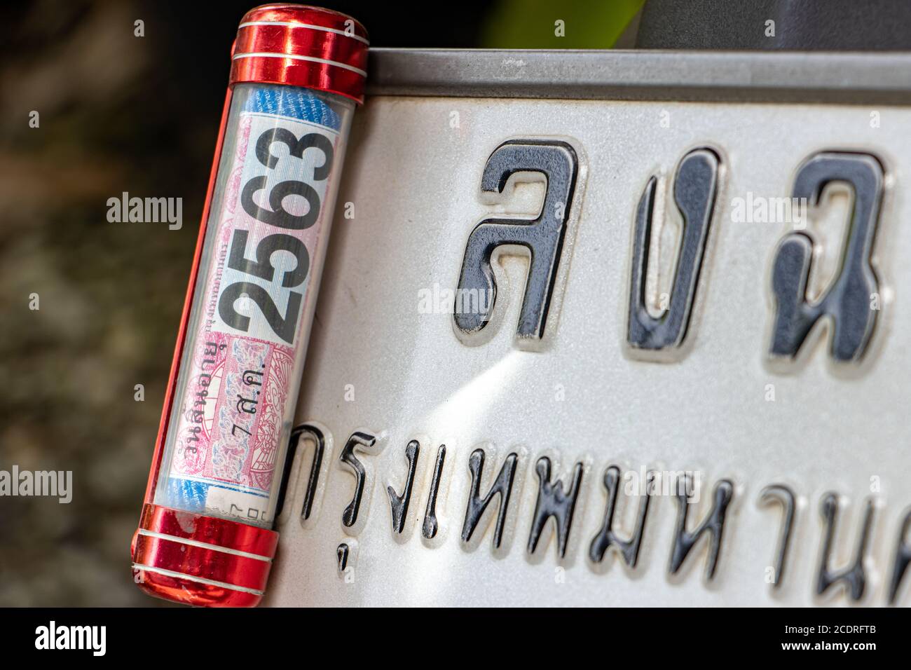 SAMUT PRAKAN, THAILAND, JUN 23 2020, Confirmation of the insurance in the steel box attached to the registration plate of the vehicle - motorcycle. Stock Photo