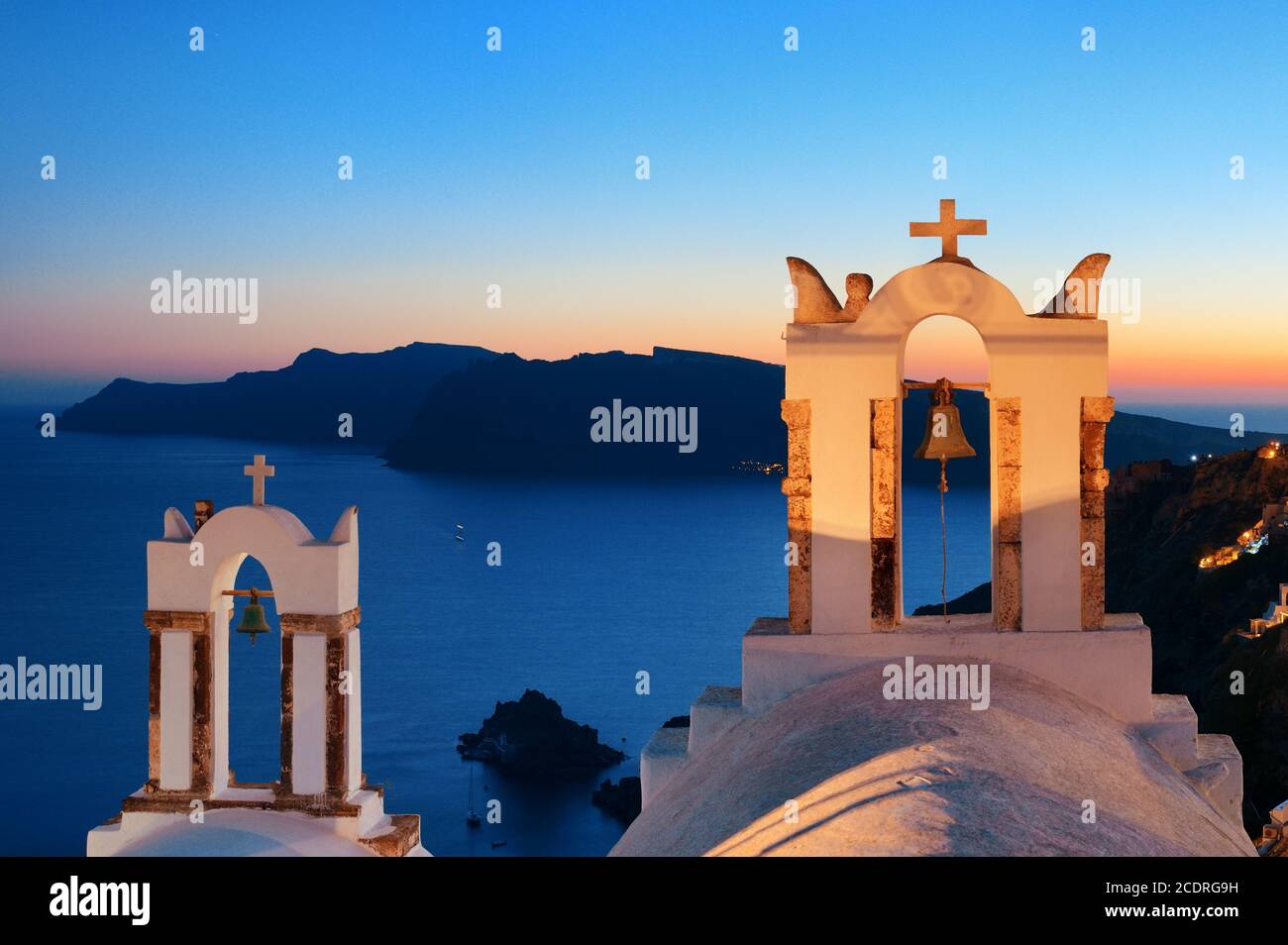 Santorini skyline at night with buildings and bell tower in Greece. Stock Photo