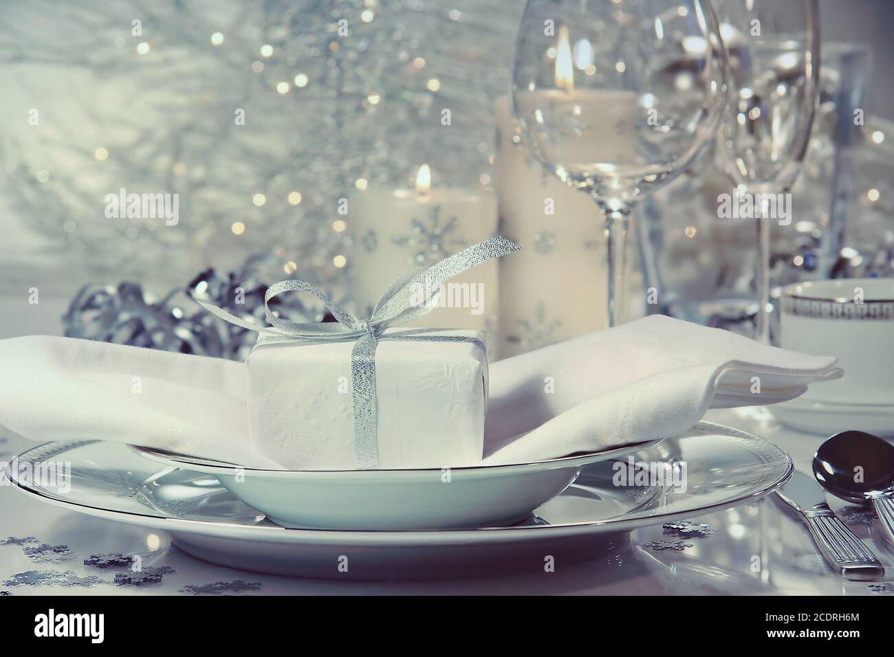 Festive dinner setting with gift Stock Photo