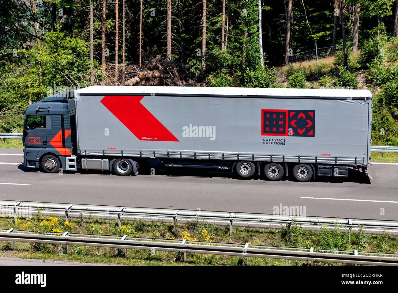 Schlimgen MAN TGX truck with curtainside trailer on motorway. Stock Photo