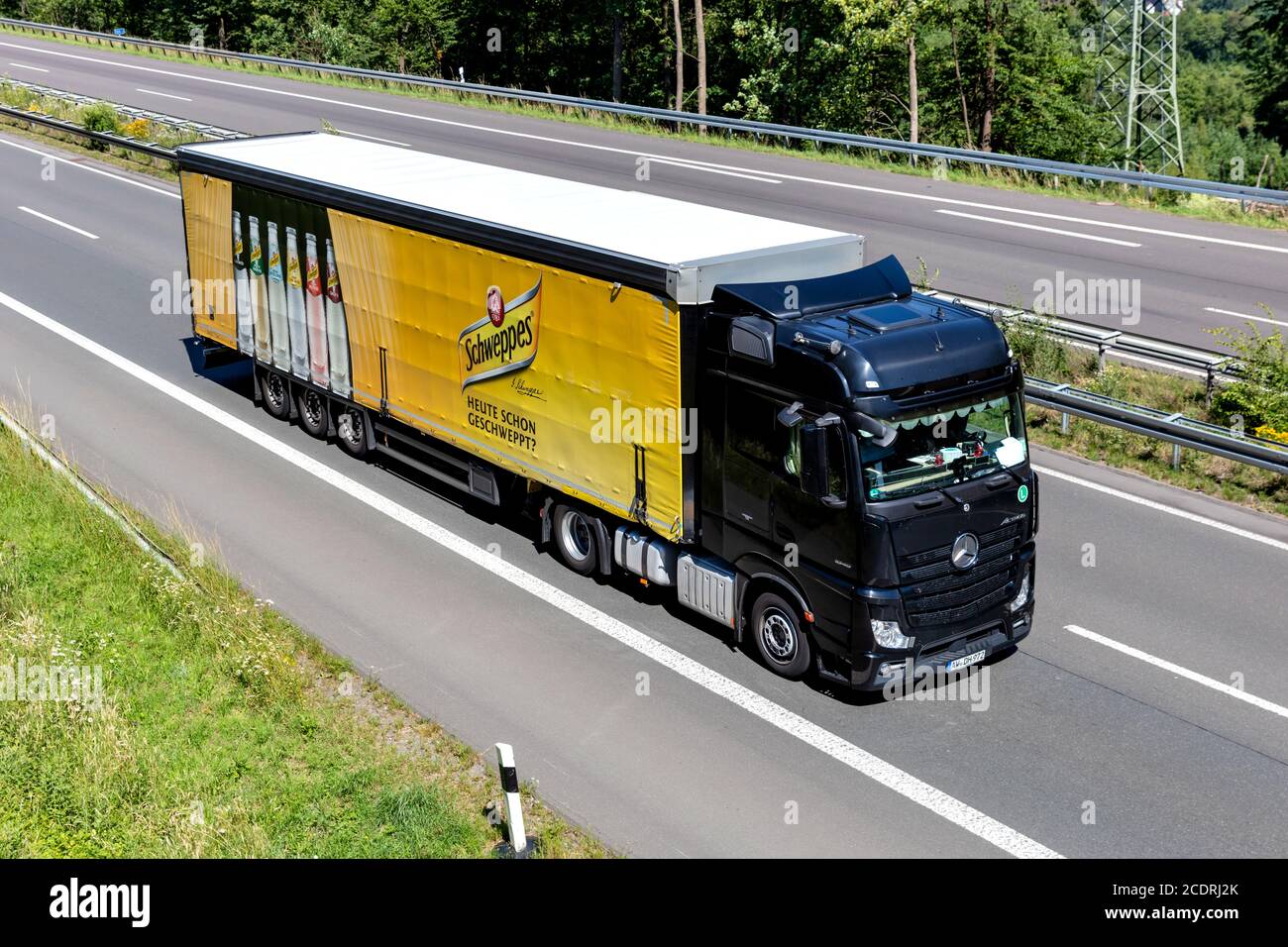 Schweppes Mercedes-Benz Actros truck with curtainside trailer on motorway. Stock Photo