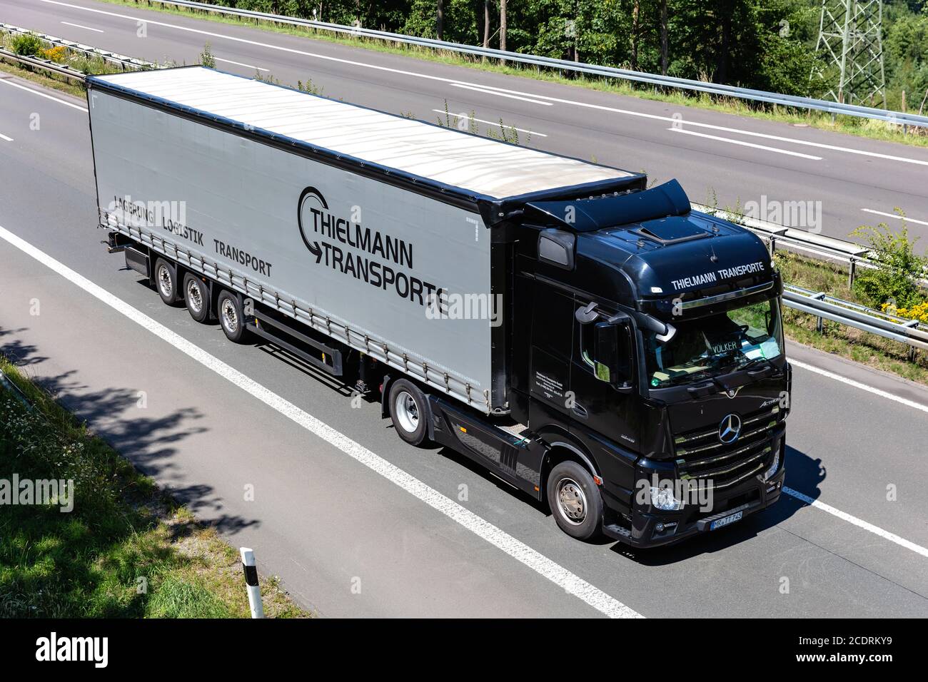 Thielmann Mercedes-Benz Actros truck with curtainside trailer on motorway. Stock Photo