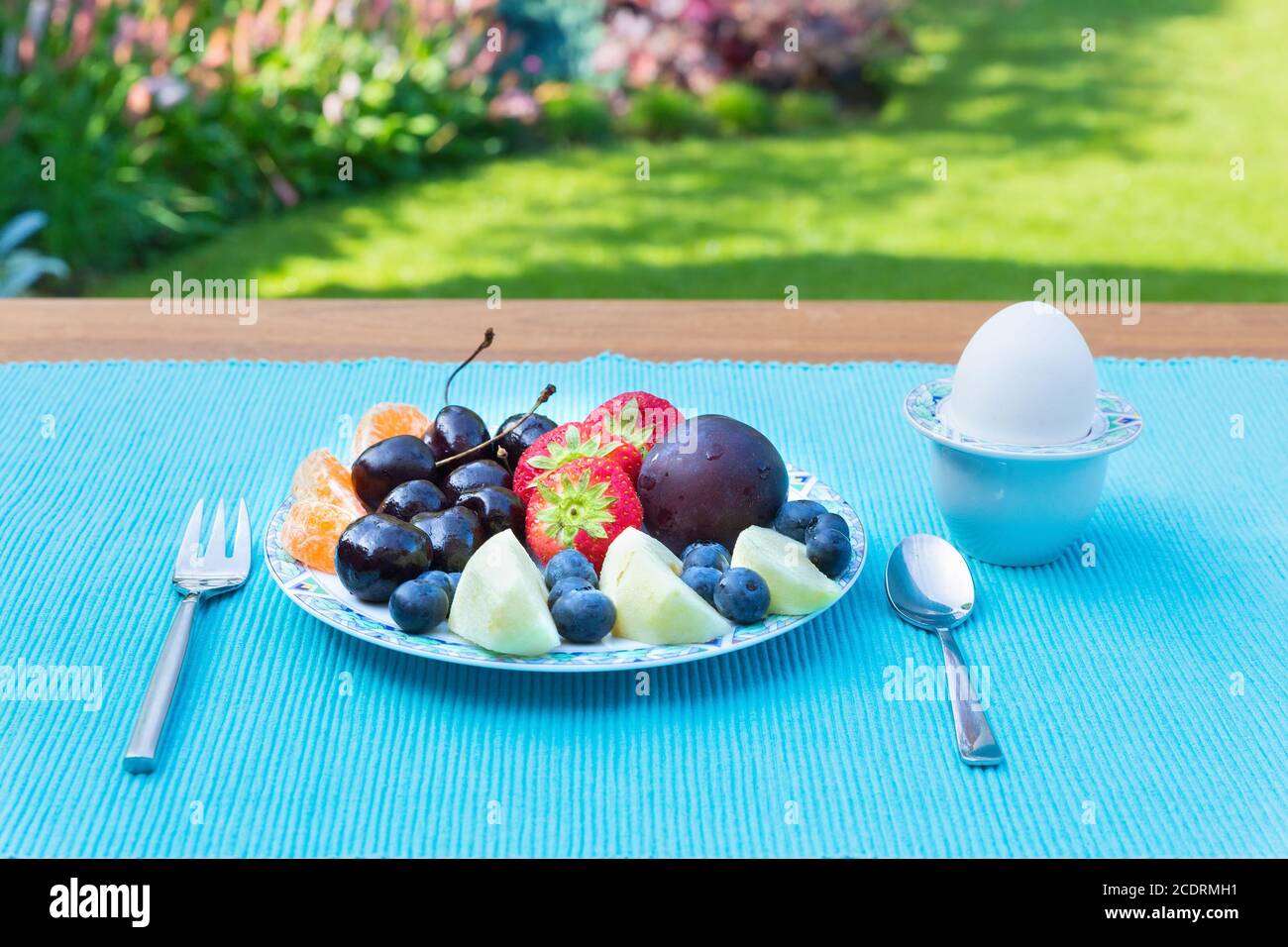Fruit plate on table outside in garden Stock Photo