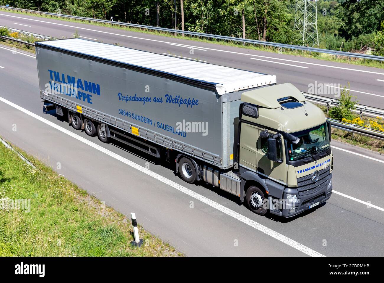 Tillmann Wellpappe Mercedes-Benz Actros truck with curtainside trailer on motorway. Stock Photo