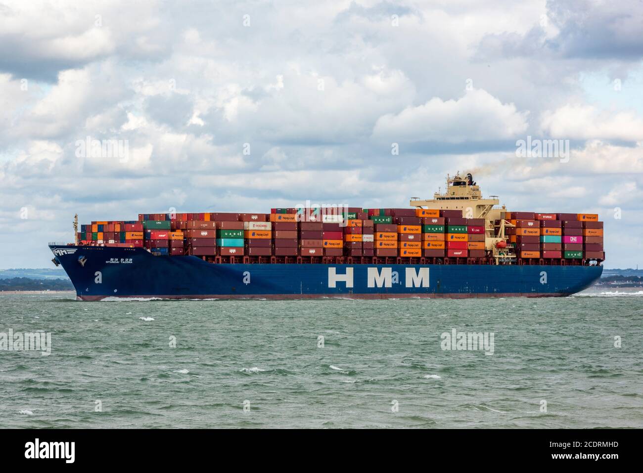 a large container cargo ship entering the solent and the port of southampton docks on the south coast of england, Stock Photo