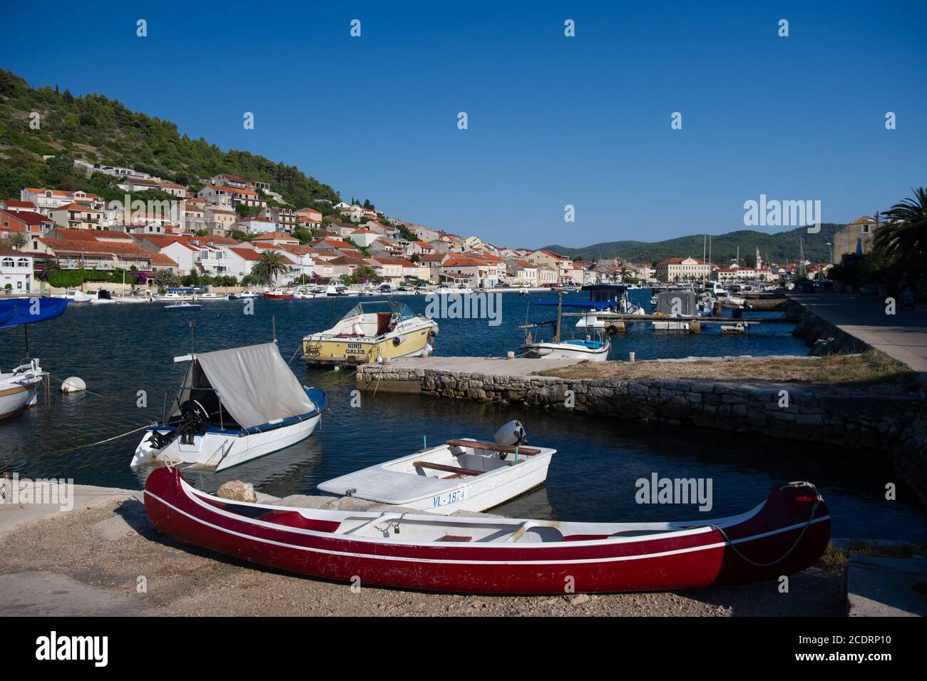 Small recreational boats at rest in a sleepy Adriatic port village. Stock Photo