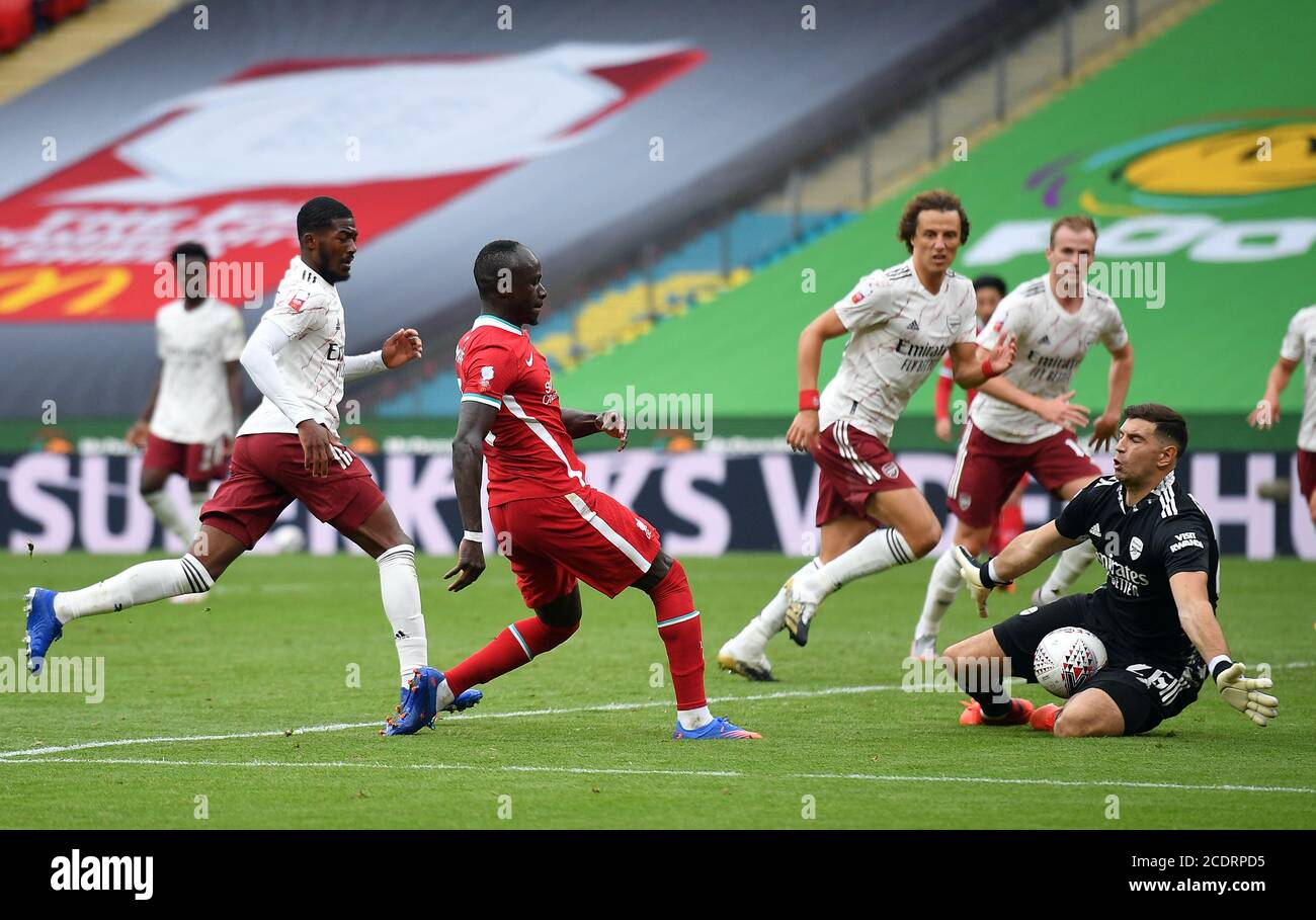 Arsenal goalkeeper Emiliano Martinez saves from Liverpool's Sadio Mane ...