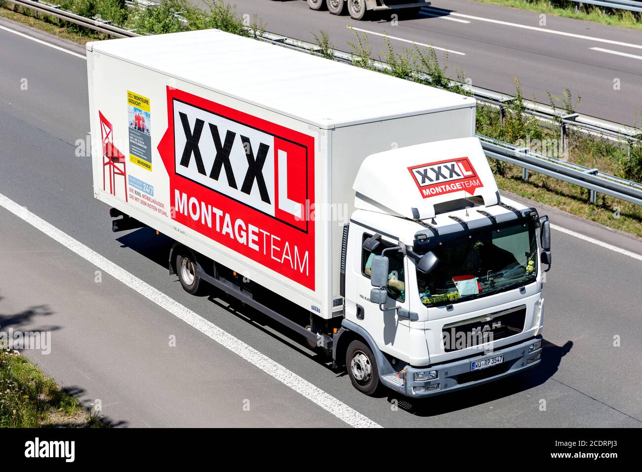 XXXL MAN TGL truck on motorway. Austria based XXXLutz is the second largest furniture retailer in the world. Stock Photo