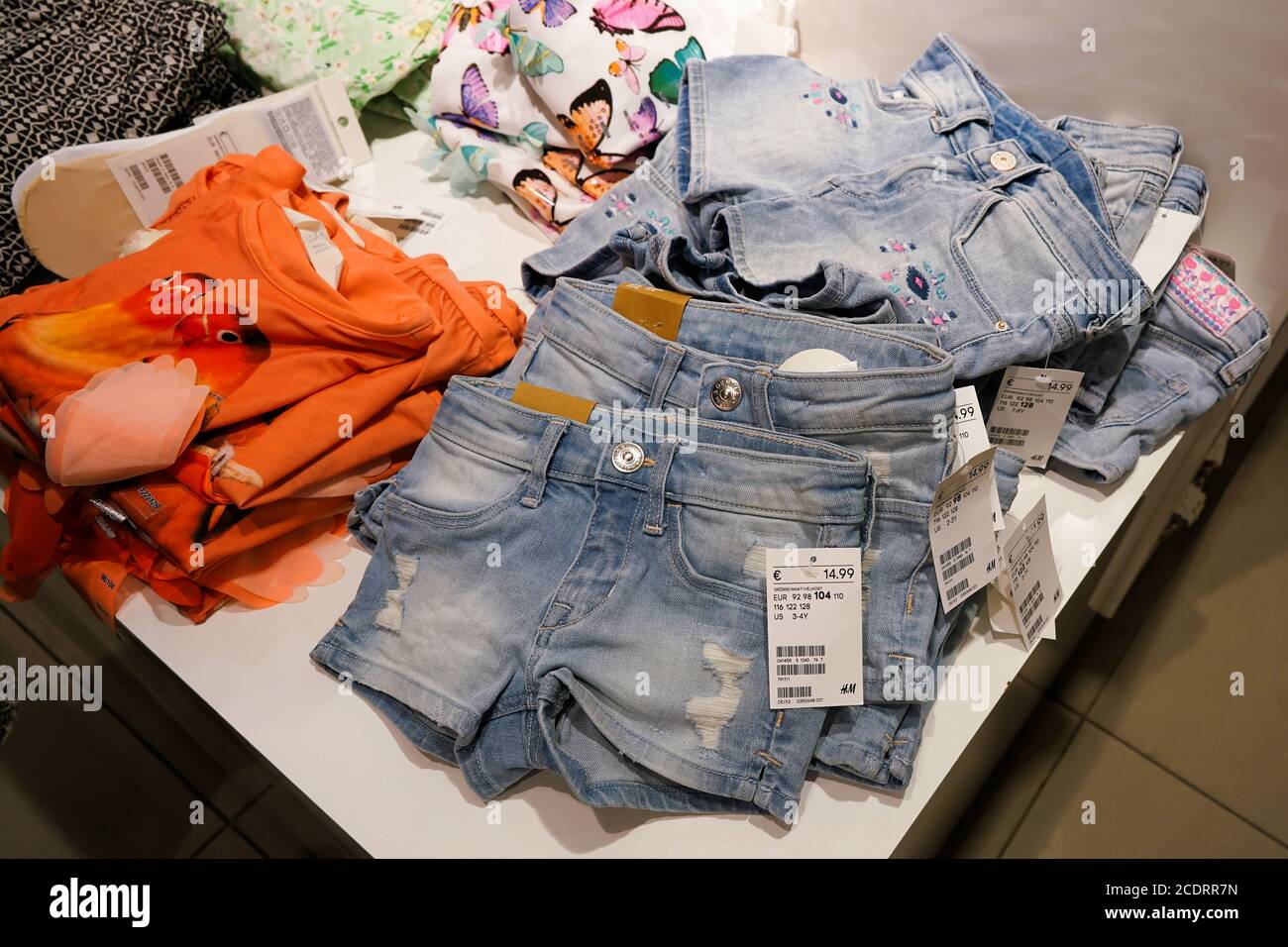 Clothing for children in a branch of H&M in the inner city of Berlin. Stock Photo