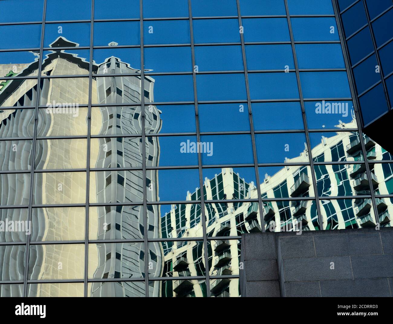 Downtown buildings are reflected in the windows of a skyscrapper in Nashville, Tennessee USA. Stock Photo