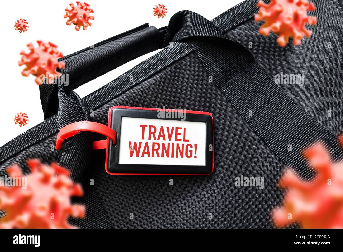Travel bag and address tag, COVID-19 travel warning Stock Photo