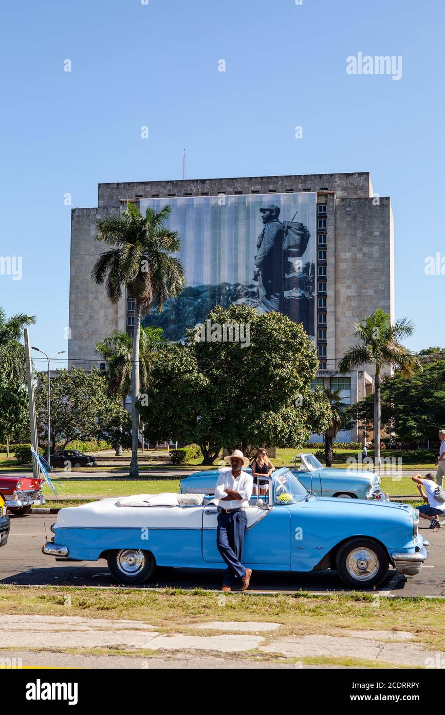Classic Car Taxi driver at Plaza de la Revolucion, Biblioteca Nacional de Cuba Jose Marti Stock Photo