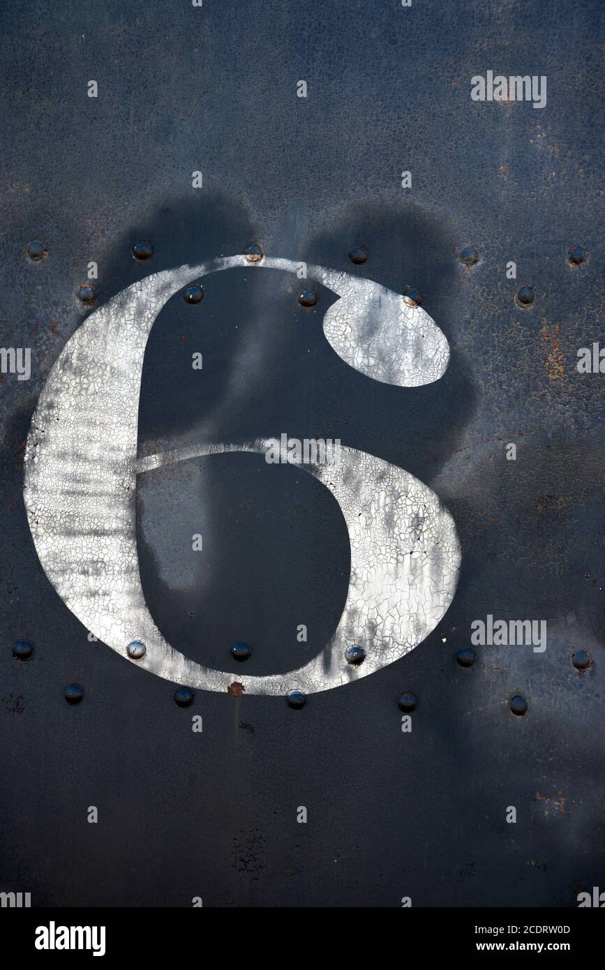 The number 6 painted on the side of a vintage railroad steam locomotive on display in Madrid, New Mexico USA. Stock Photo