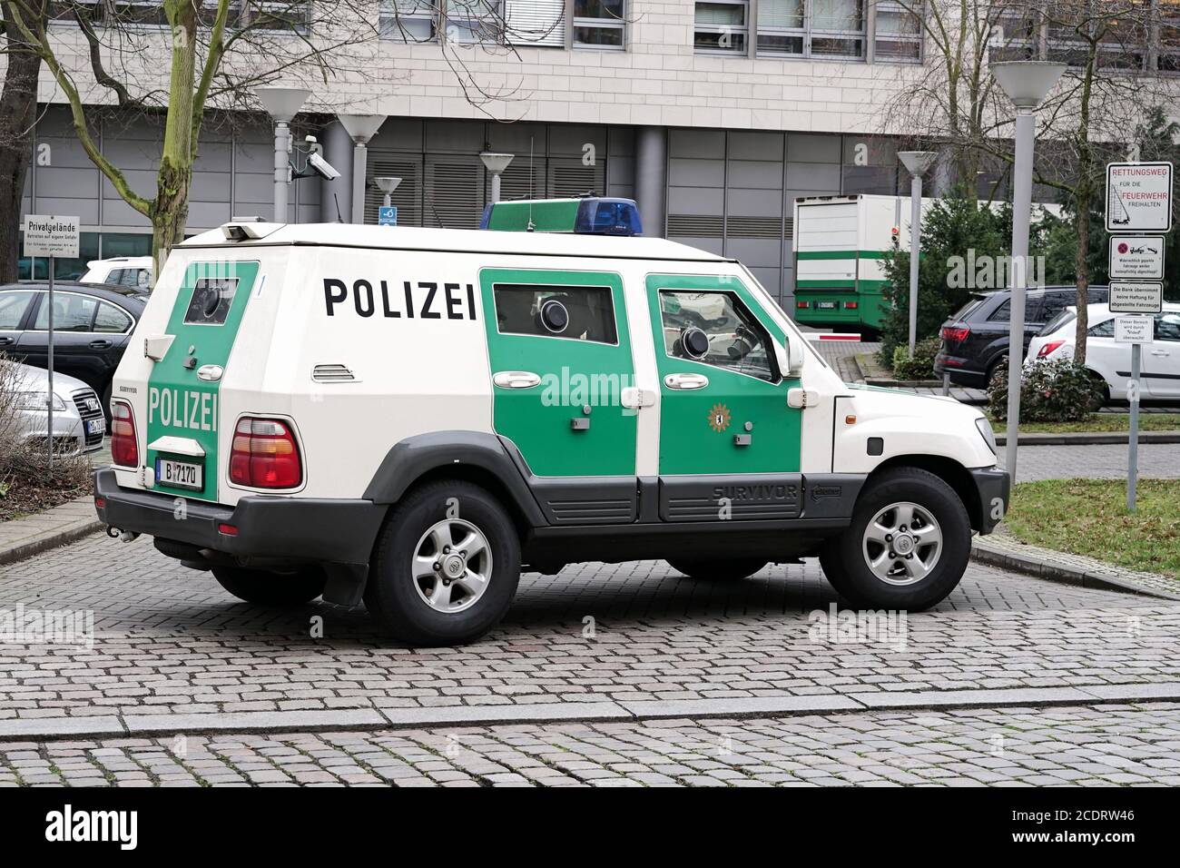 Armored police car as escort   for a money transport in the inner city of Magdeburg Stock Photo
