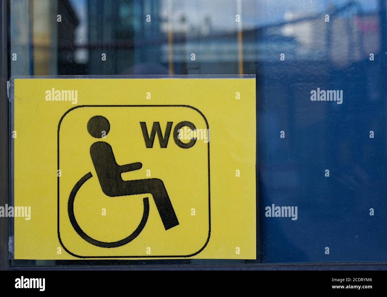 Sign on an elevator to a disabled toilette in the train station of Magdeburg Stock Photo