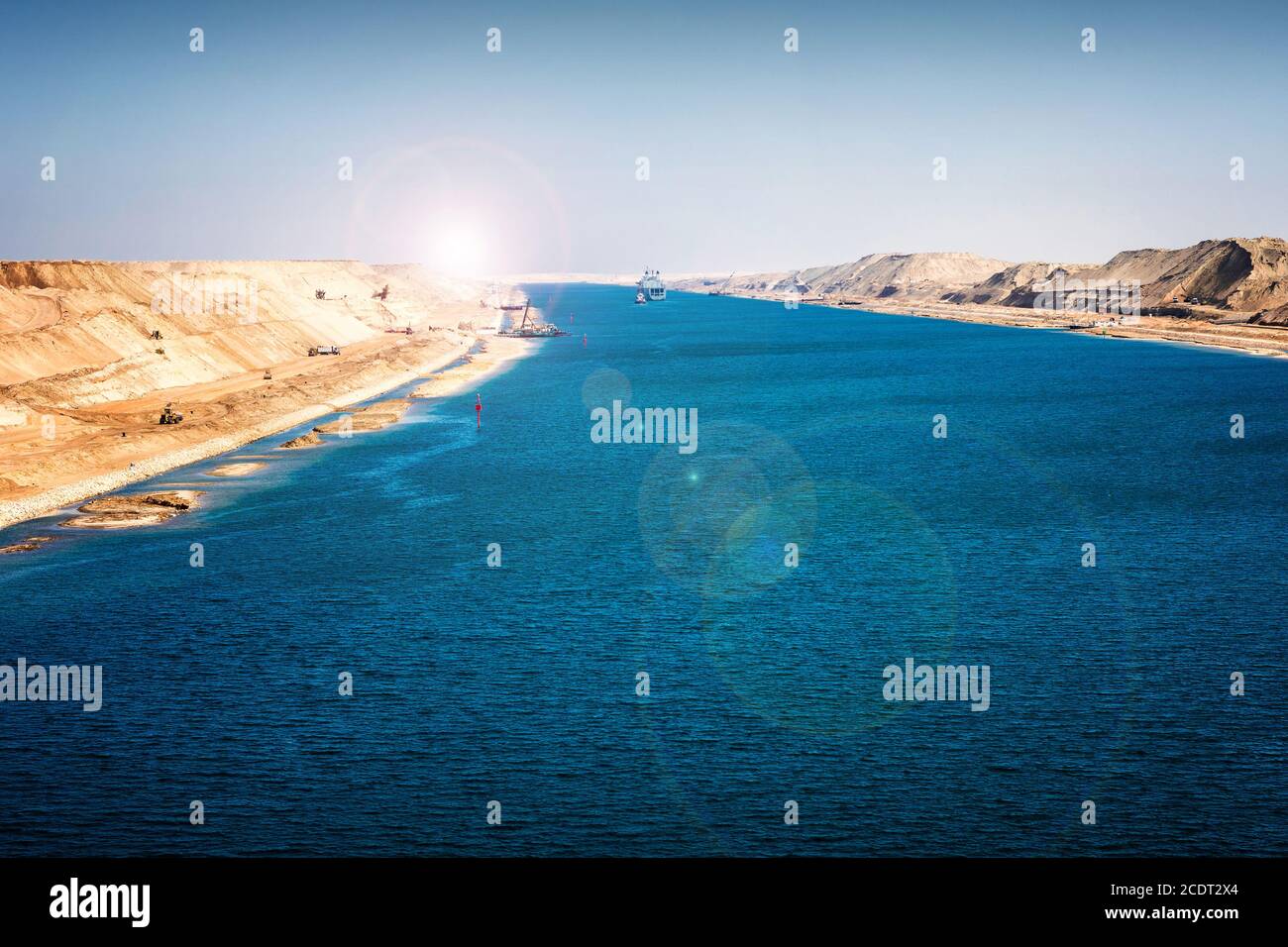 The Suez Canal - military ship and tugboat drive in the 2015 newly opened expansion canal Stock Photo