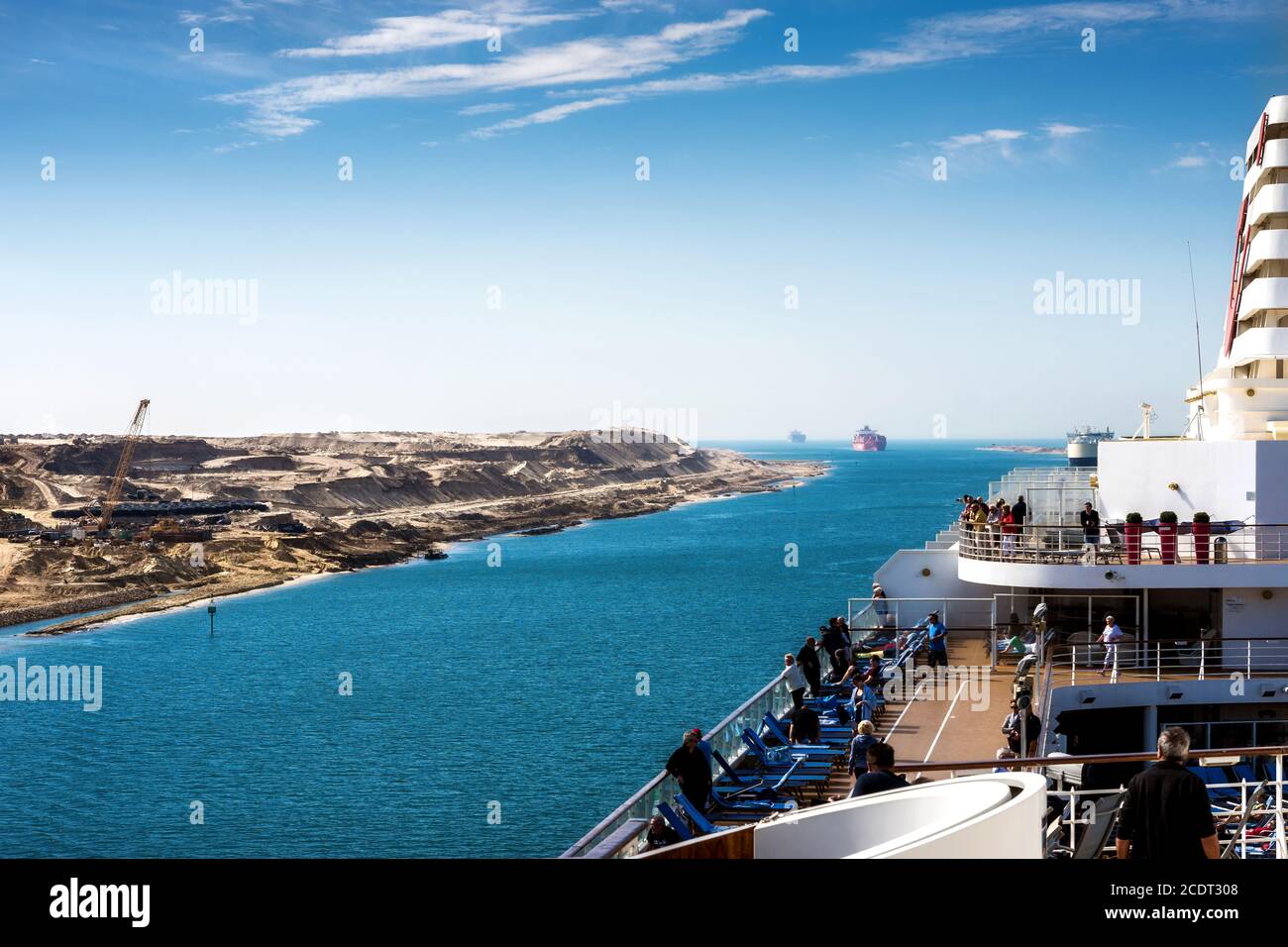 The Suez Canal - a ship convoy with a cruise ship passes the new eastern extension canal Stock Photo