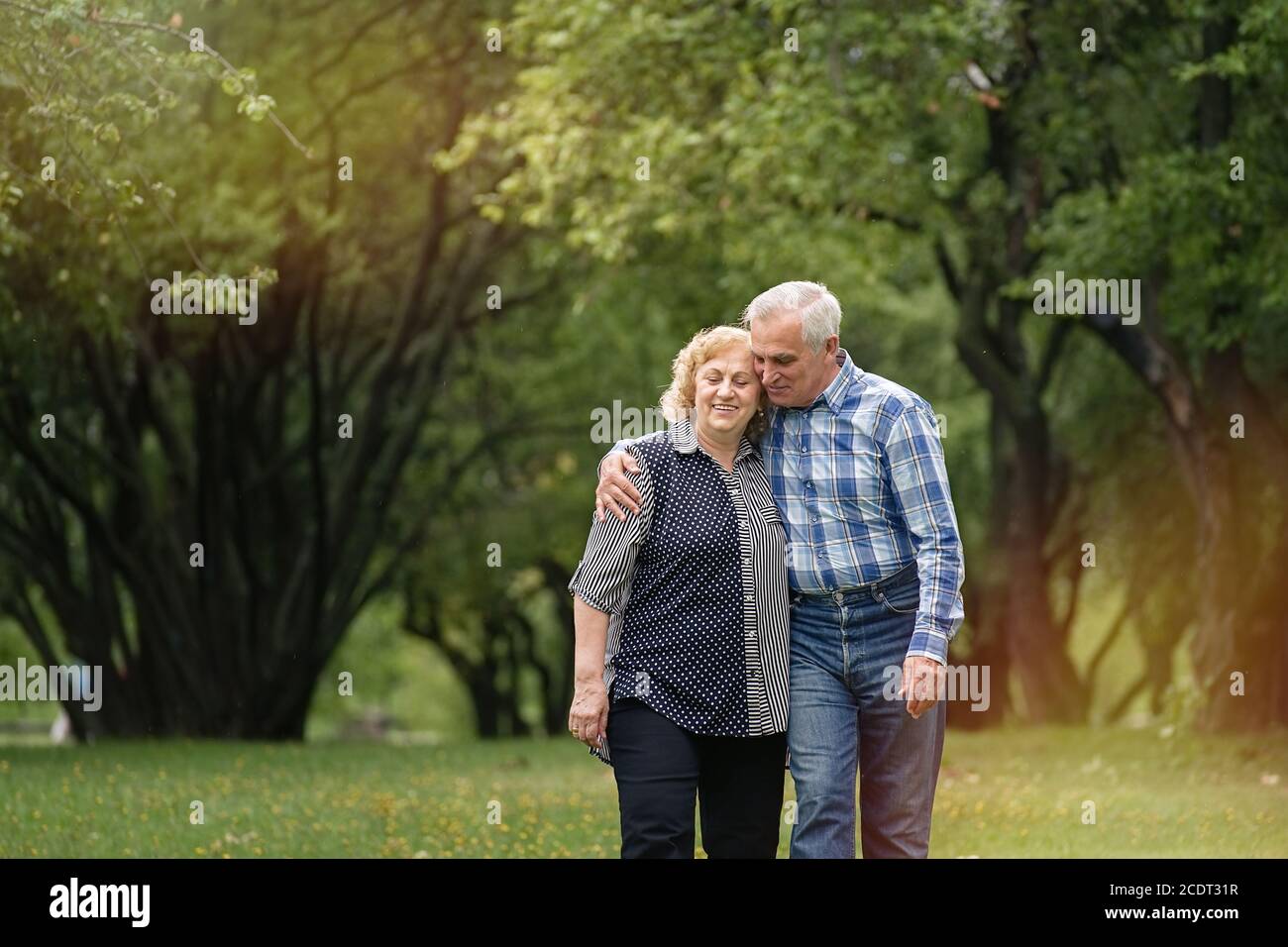 Grey hair man woman walking hi-res stock photography and images - Alamy
