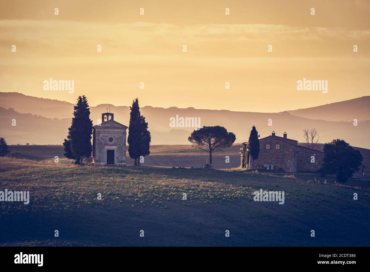 Tuscany landscape at sunrise. Chapel of Madonna di Vitaleta, San Quirico d#39;Orcia, Italy Stock Photo