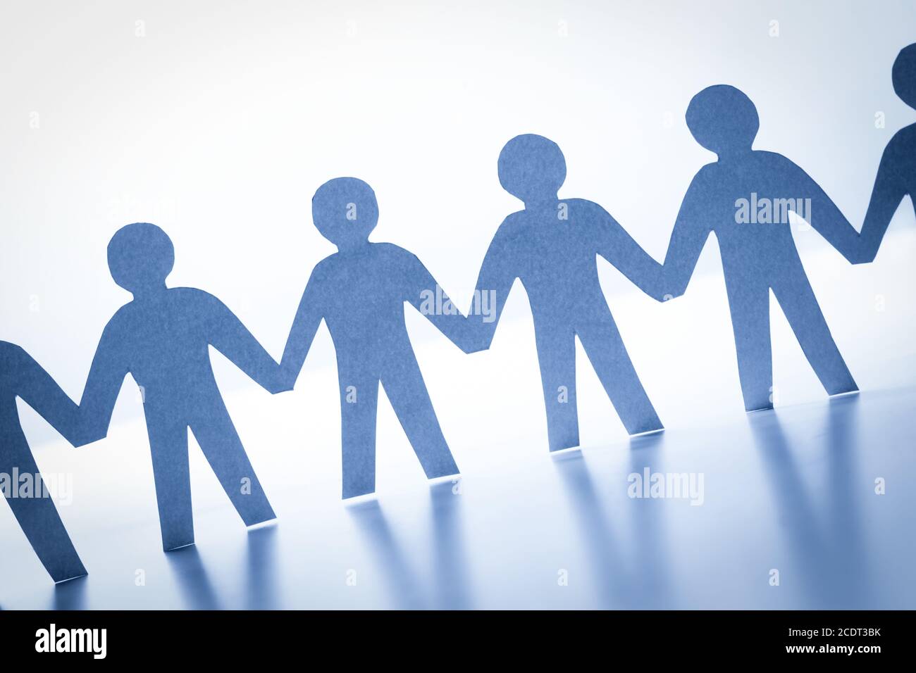 Paper people standing together hand in hand. Team, society, business concept Stock Photo