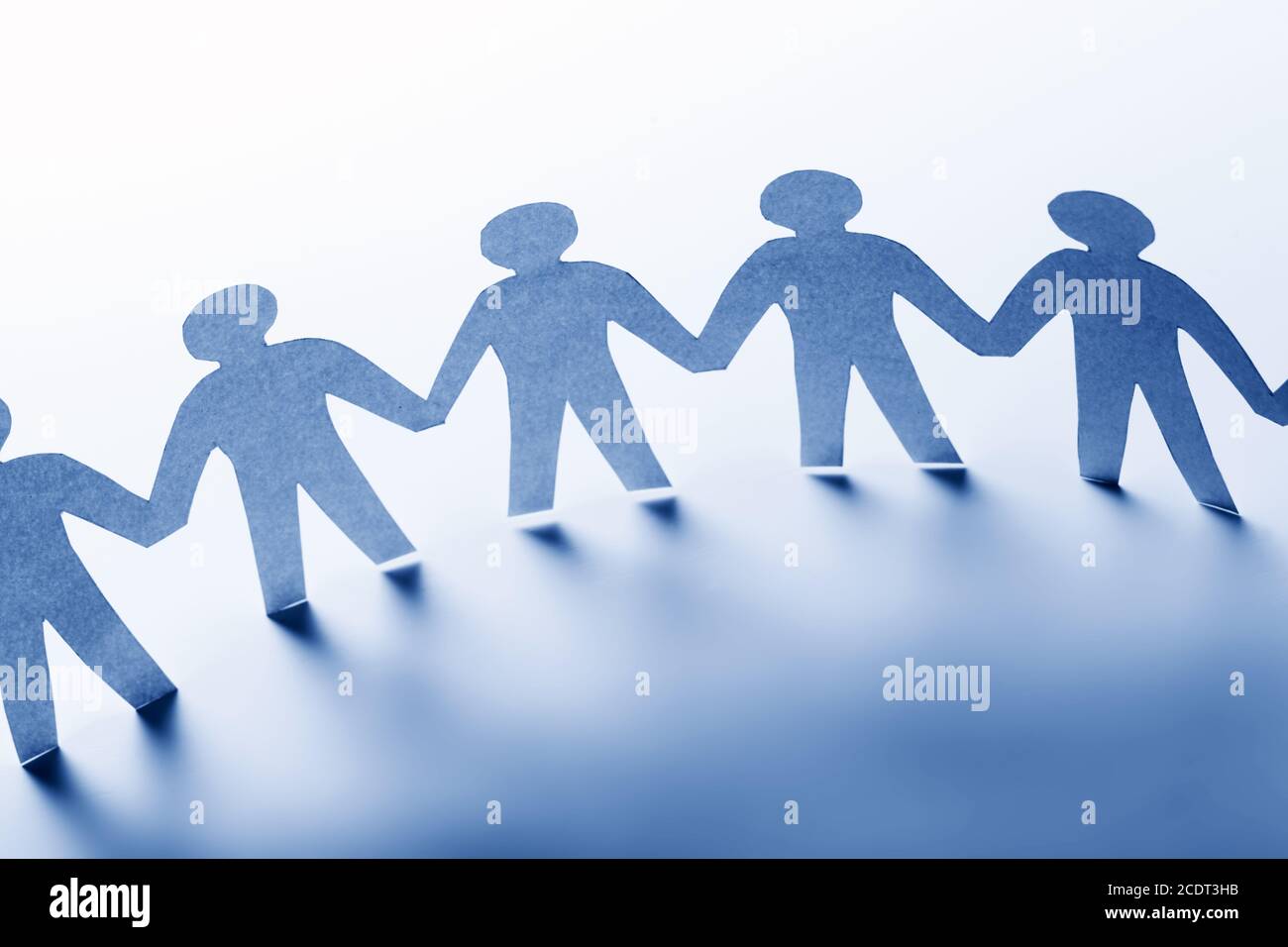 Paper people standing together hand in hand. Team, society, business concept Stock Photo