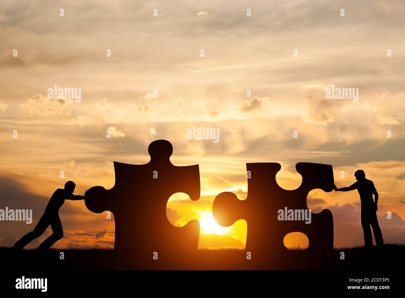 Two men connect two puzzle pieces. Concept of business solution, solving a problem. Stock Photo