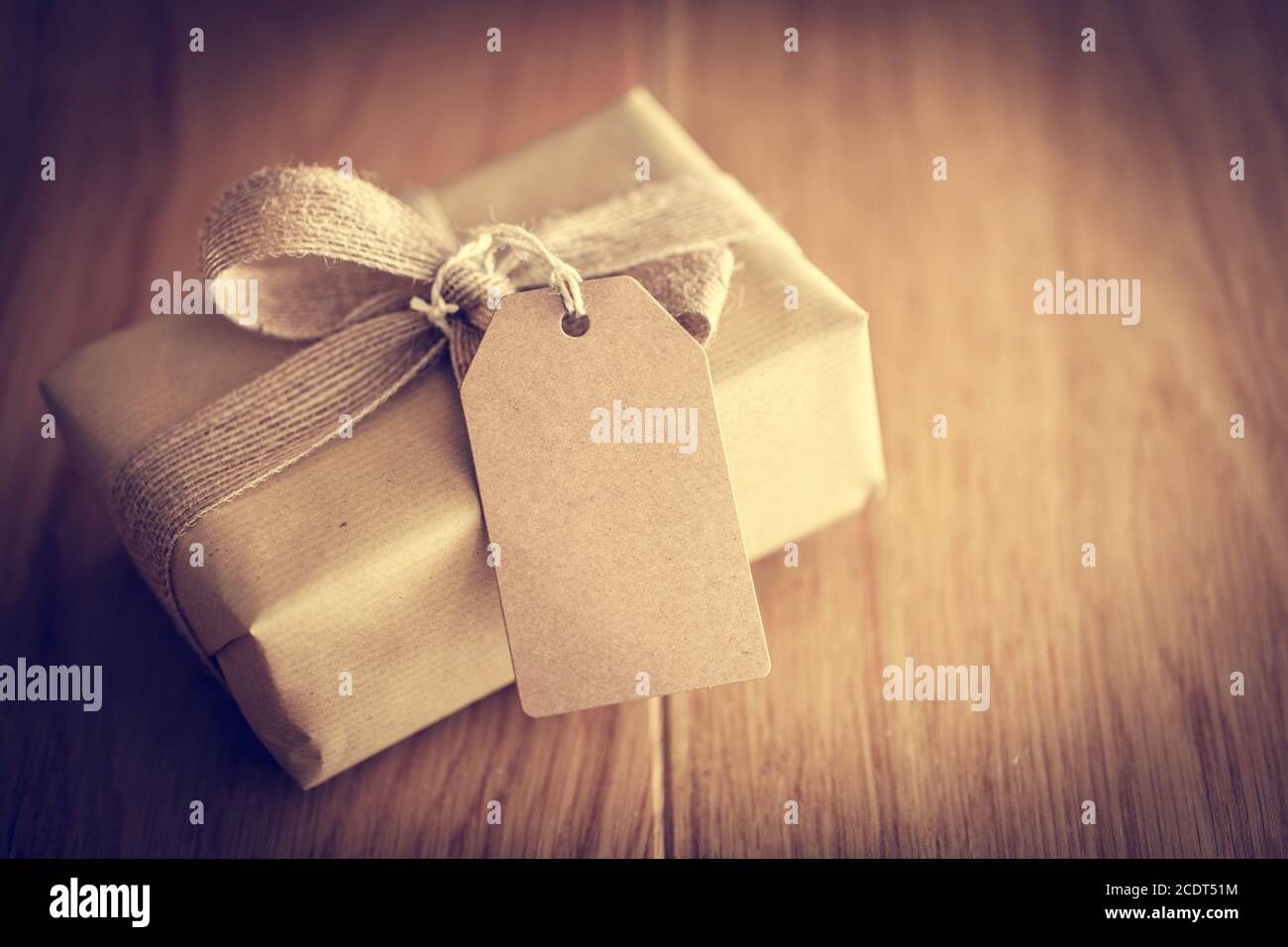 Rustic retro gift, present box with tag. Christmas time, eco paper wrap. Stock Photo