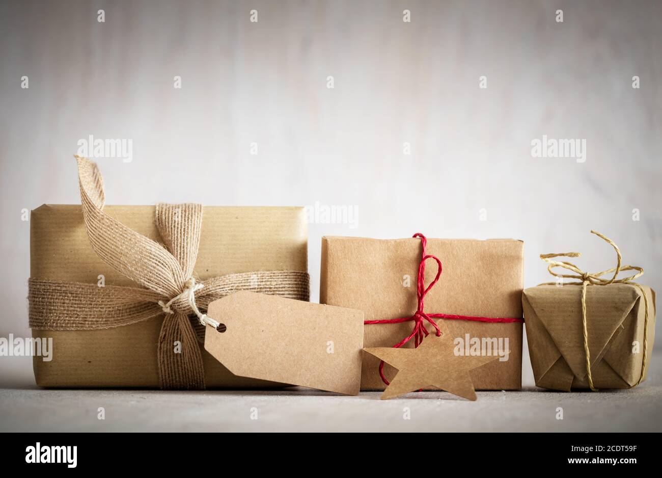 Rustic retro gifts, present boxes with tag. Christmas time, eco paper wrap. Stock Photo