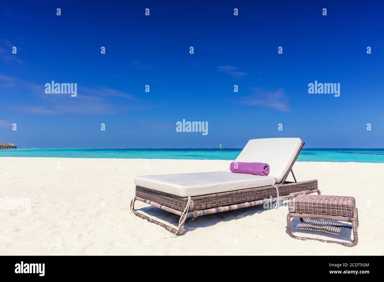 Deckchair on sandy tropical beacha a small island resort in Maldives, Indian Ocean Stock Photo