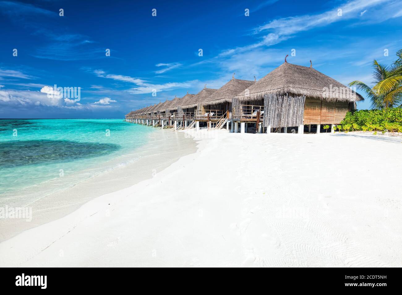 Beach and water villas on a small island resort in Maldives, Indian Ocean. Stock Photo
