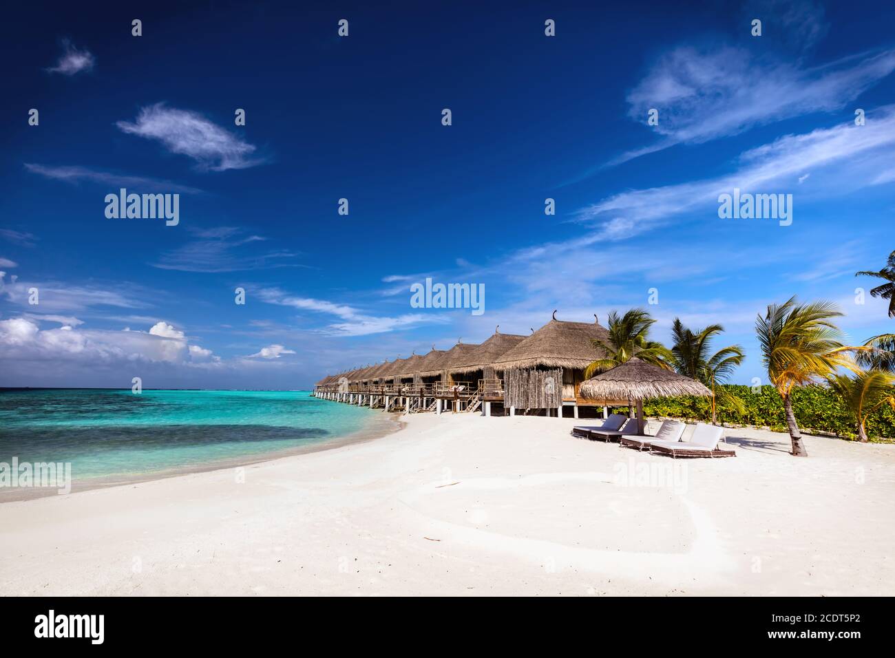 Beach and water villas on a small island resort in Maldives, Indian Ocean. Stock Photo