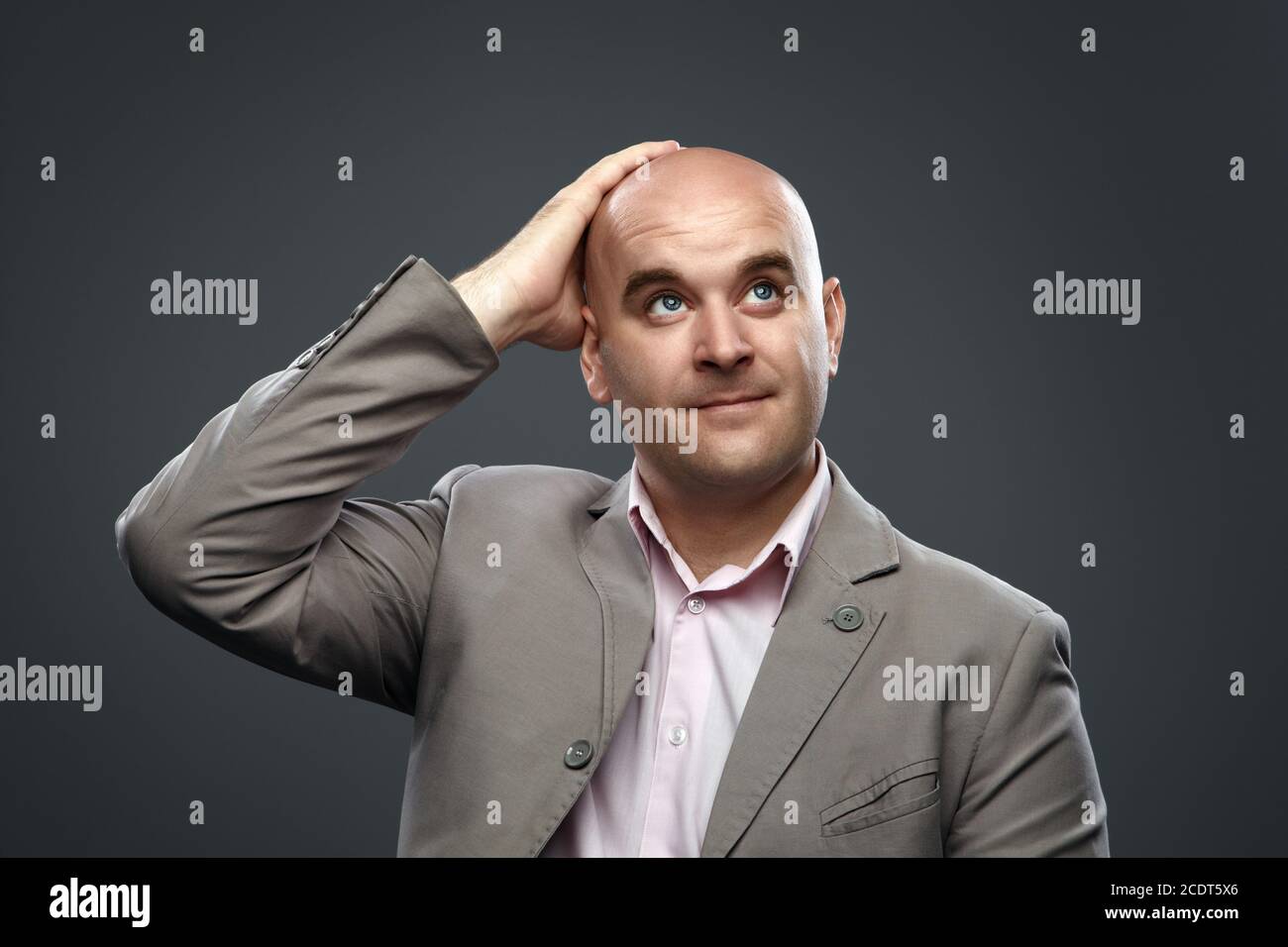 Bald man thought about and put his hand on his head Stock Photo - Alamy